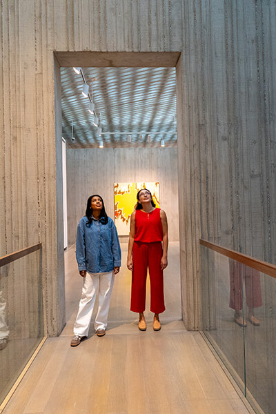 Two women look up at the ceiling at the Clyfford Still Museum