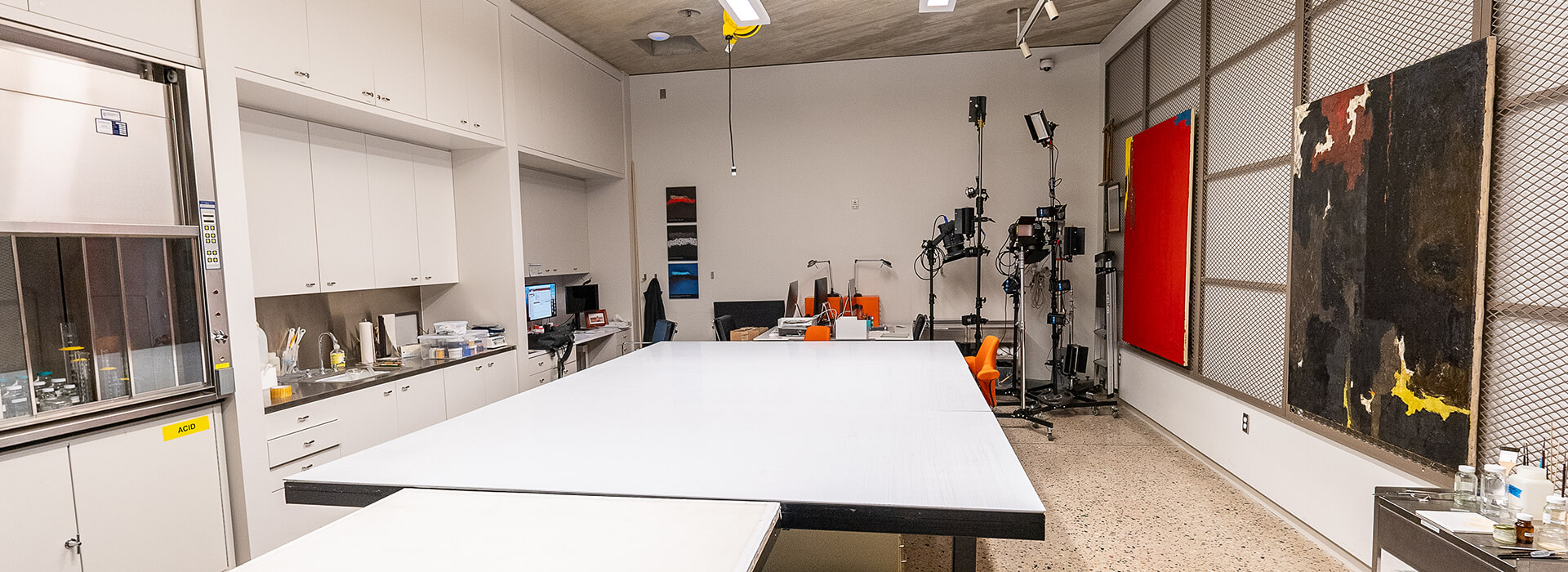 Conservation Lab with paintings on a rack and conservation materials