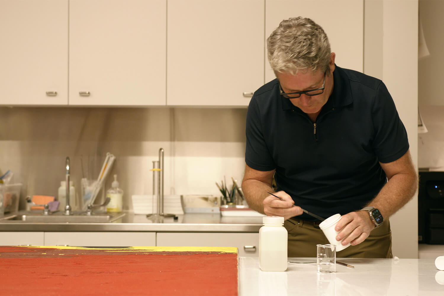 James Squires works on a painting in the Conservation Lab