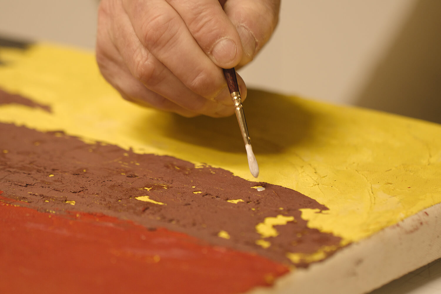 James Squires works on a painting in the Conservation Lab