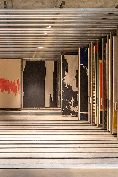 Abstract paintings by Clyfford Still on racks