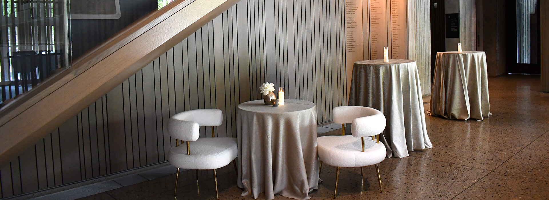 Staircase with decorated tables under it