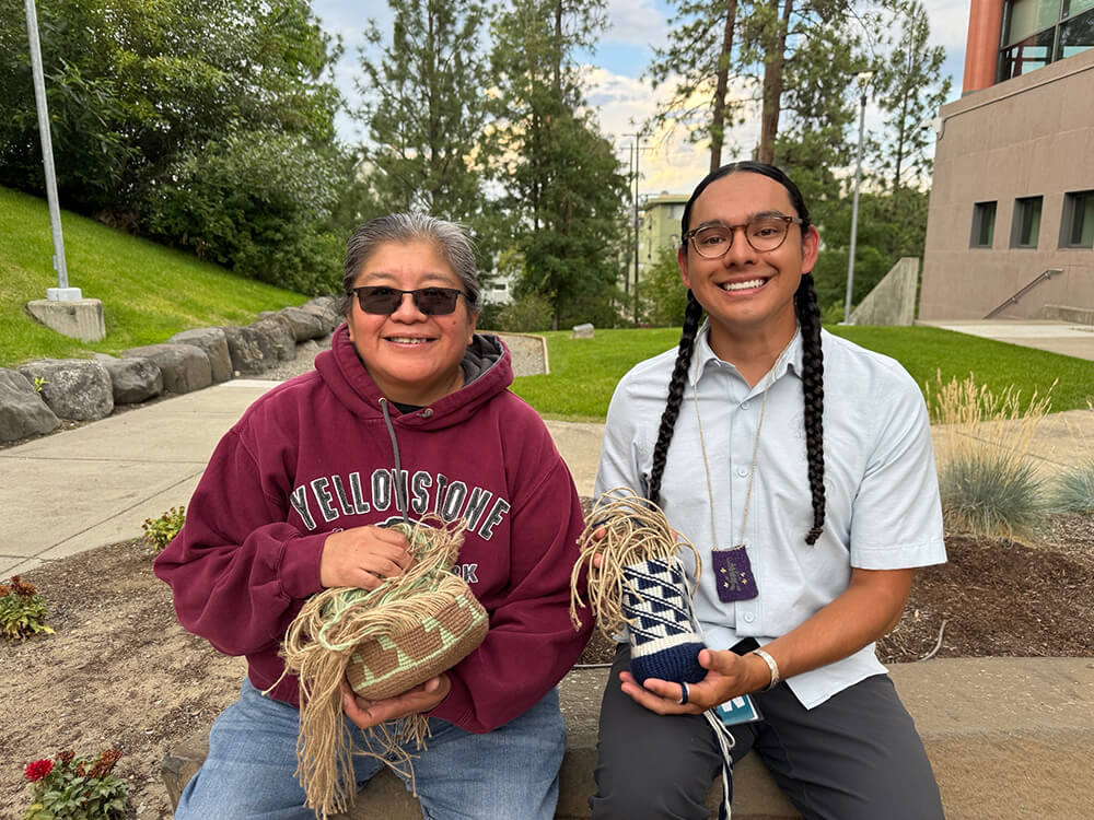 Julie Edwards and Shawn Gunnier holding woven baskets