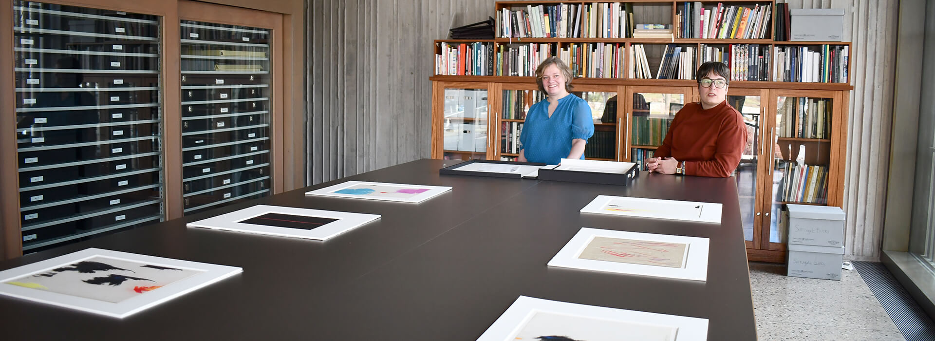 Two people talk to each other behind the scenes at the Still