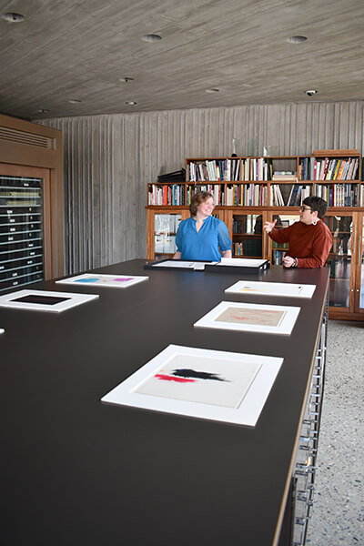 Two people talk to each other behind the scenes at the Still